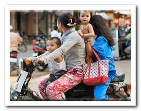 Motorcycle with two woman and two infants